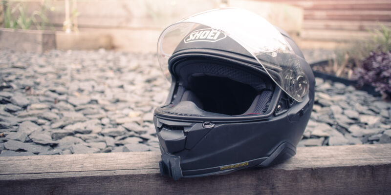 A motorcycle helmet sitting on a wooden sleeper
